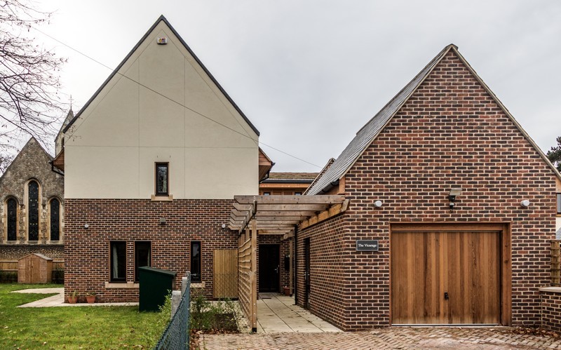 Photo showing the completed Vicarage, looking west with the church in the background on the left, the east wall window visible