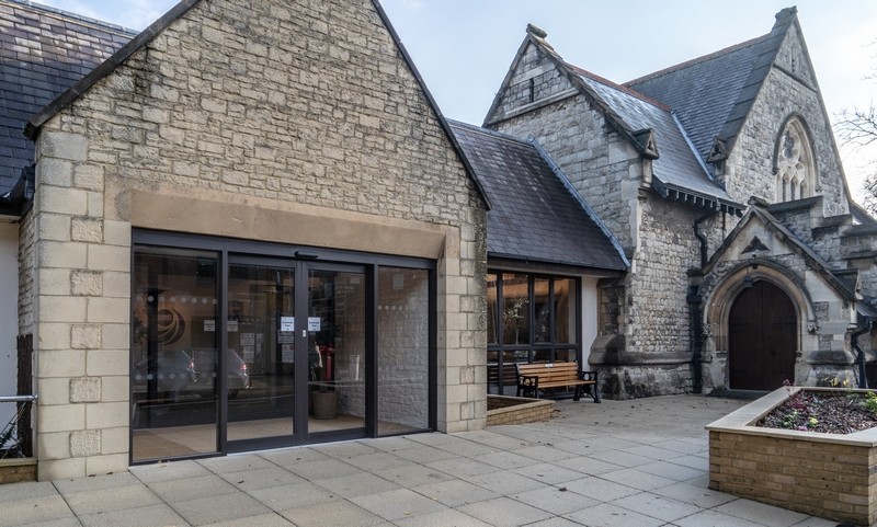 Photo of the new entrance with the old side entrance to the church in view