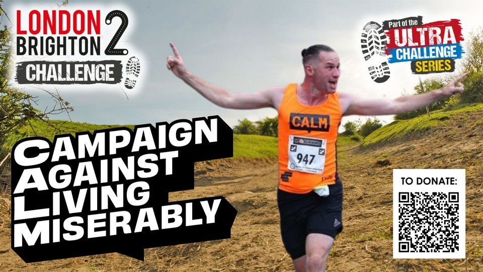 Campaign Against Living Miserably - London 2 Brighton Challenge - Part of the Ultra Challenge Series - a picture of Rob Shrimpton in running gear, orange running shirt with CALM logo and number 947, posed as if crossing the finishing line, against a green countryside background