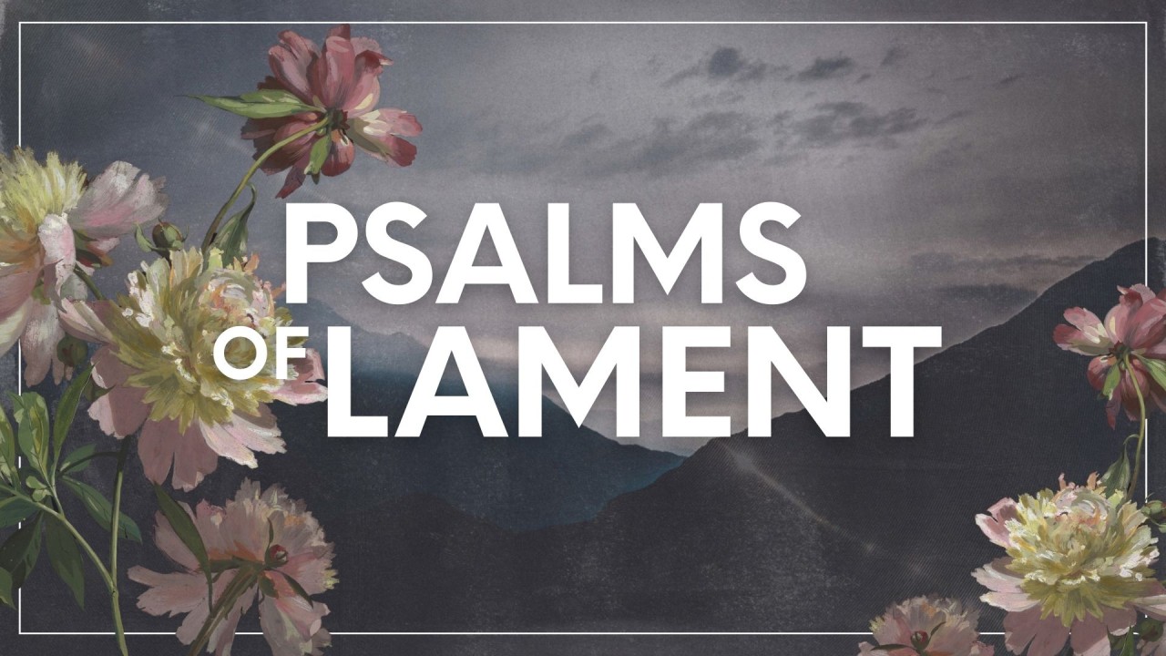 Psalms of Lament - with flowers on either side and a sombre background showing a darkened mountainous landscape under grey skies