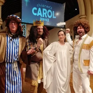 Characters in costume from the Children's Carol Service in 2022